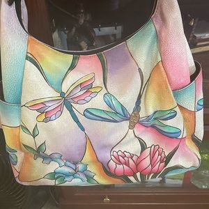 Like new Anuschka crossbody bag. Dragonfly pattern